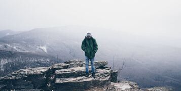 Winter Coat Man on Rocks